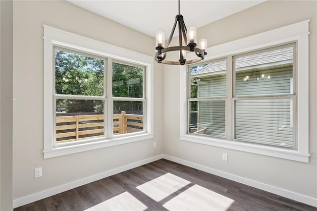 4251 Poplar Dr, Slidell, LA 70461 - unfurnished dining area featuring a chandelier, dark wood-style floors, and baseboards