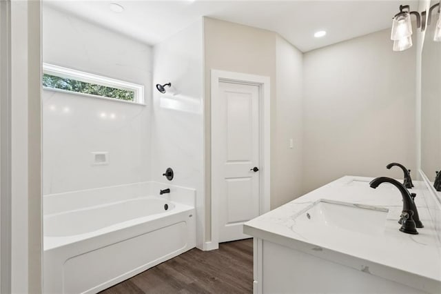 4251 Poplar Dr, Slidell, LA 70461 - full bath with wood finished floors, shower / bath combination, double vanity, and recessed lighting