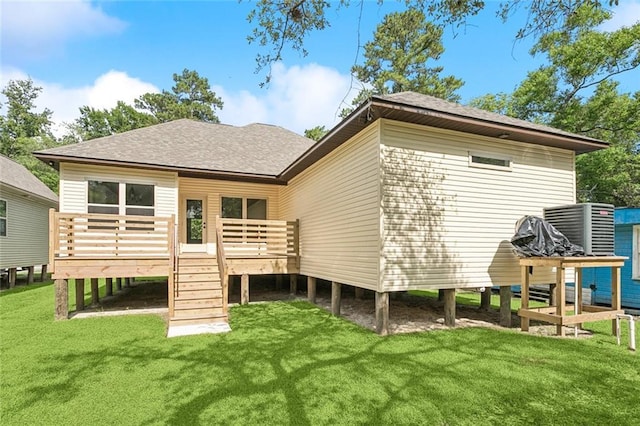 4251 Poplar Dr, Slidell, LA 70461 - rear view of house featuring roof with shingles, a wooden deck, and a lawn