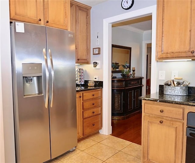 3444 Texas Ave, Kenner, LA 70065 - kitchen featuring stainless steel fridge with ice dispenser, ornamental molding, dark stone countertops, and light tile patterned floors