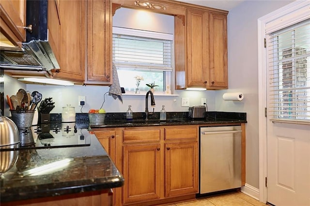 3444 Texas Ave, Kenner, LA 70065 - kitchen featuring dishwasher, a sink, brown cabinetry, dark stone countertops, and light tile patterned flooring