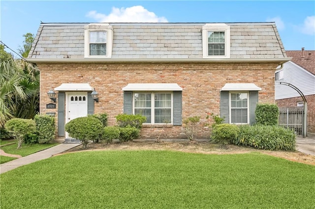 4909 Sunny Pl, Metairie, LA 70006 - view of front of home featuring mansard roof, brick siding, and a high end roof