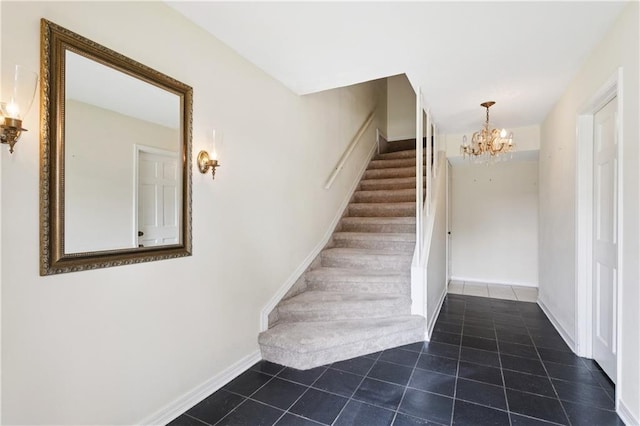 4909 Sunny Pl, Metairie, LA 70006 - stairway featuring a chandelier, tile patterned floors, and baseboards