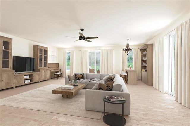 4909 Sunny Pl, Metairie, LA 70006 - living room featuring ceiling fan, light wood finished floors, and a chandelier