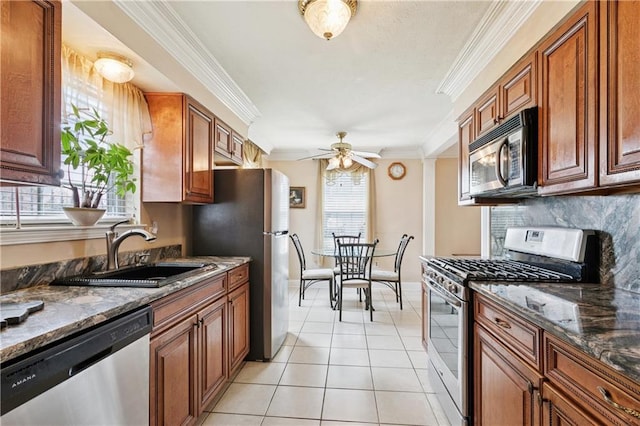 4909 Sunny Pl, Metairie, LA 70006 - kitchen with appliances with stainless steel finishes, brown cabinets, a ceiling fan, light tile patterned floors, and a sink