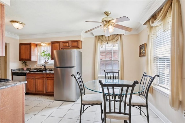 4909 Sunny Pl, Metairie, LA 70006 - dining room featuring a ceiling fan, ornamental molding, light tile patterned flooring, and plenty of natural light