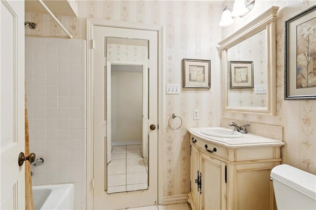 4909 Sunny Pl, Metairie, LA 70006 - bathroom featuring wallpapered walls, vanity, toilet, tile patterned flooring, and bathtub / shower combination