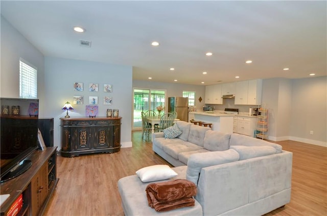 141 Audubon Dr, Mandeville, LA 70471 - living area with recessed lighting, light wood-type flooring, and baseboards