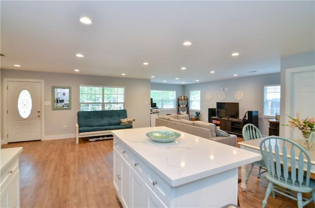 141 Audubon Dr, Mandeville, LA 70471 - kitchen with open floor plan, recessed lighting, white cabinetry, a kitchen island, and light wood-type flooring