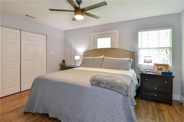 141 Audubon Dr, Mandeville, LA 70471 - bedroom featuring wood finished floors, a closet, and a ceiling fan