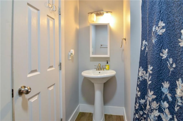 141 Audubon Dr, Mandeville, LA 70471 - bathroom featuring baseboards, wood finished floors, and a sink