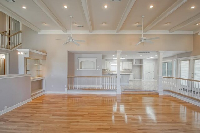 6300 W Metairie Ave, Metairie, LA 70003 - unfurnished living room featuring a ceiling fan, decorative columns, light wood-style flooring, beamed ceiling, and crown molding