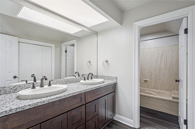 240 Silver Maple Dr, Mandeville, LA 70471 - bathroom with double vanity, wood finished floors, shower / bathtub combination, and baseboards