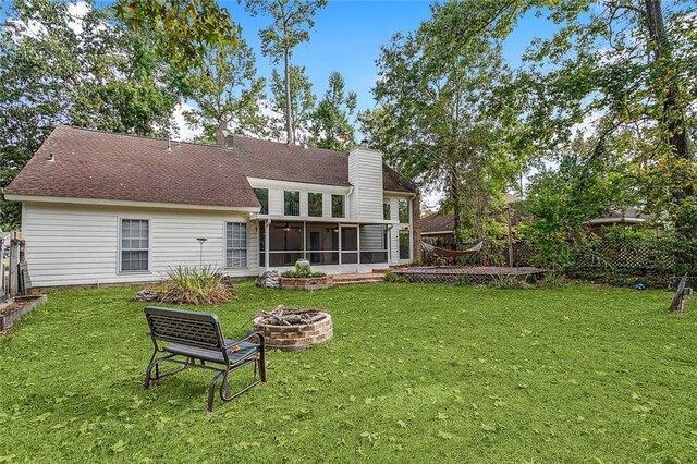 240 Silver Maple Dr, Mandeville, LA 70471 - rear view of house with a sunroom, a fire pit, a chimney, and a shingled roof