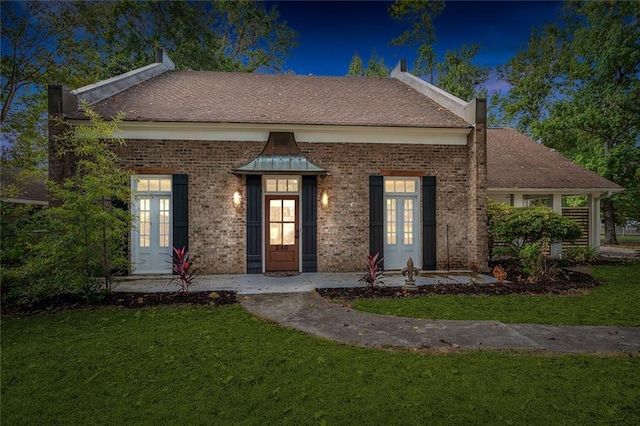 240 Silver Maple Dr, Mandeville, LA 70471 - view of front of house with french doors, a front lawn, and brick siding