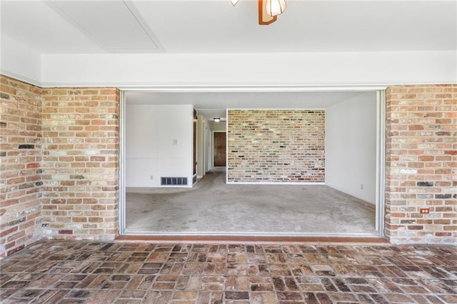 3410 Plymouth Pl, New Orleans, LA 70131 - unfurnished living room featuring brick wall and brick flooring