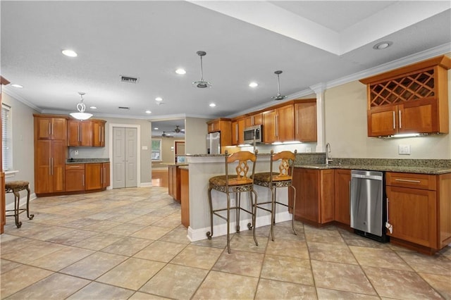 3913 Bellview St, Metairie, LA 70002 - kitchen with appliances with stainless steel finishes, crown molding, brown cabinets, a sink, and recessed lighting