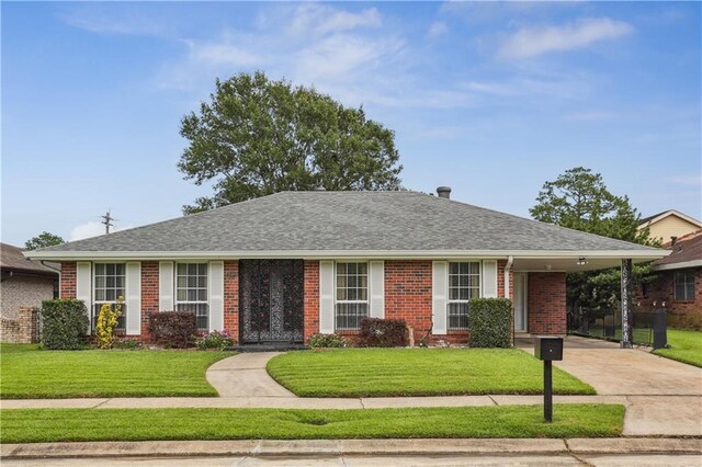 4811 Perelli Dr, New Orleans, LA 70127 - single story home with brick siding, a front lawn, concrete driveway, and a carport