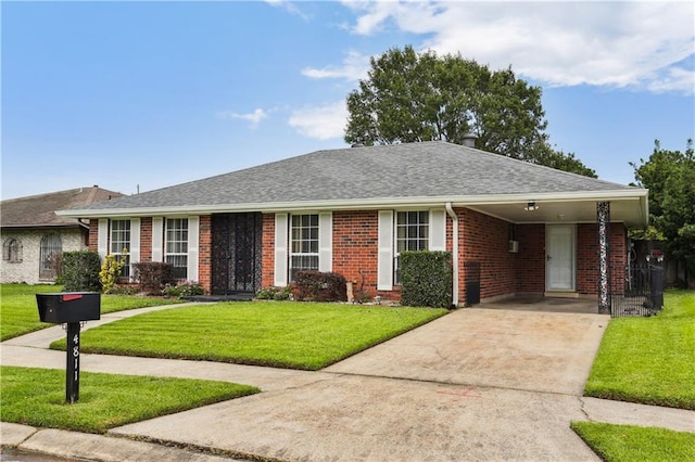 4811 Perelli Dr, New Orleans, LA 70127 - ranch-style house featuring concrete driveway, brick siding, a front yard, an attached carport, and a shingled roof