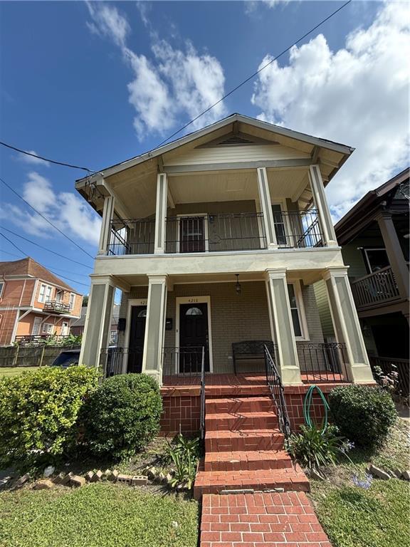 4218 S Liberty St, New Orleans, LA 70115 - view of front of property with a balcony, covered porch, and brick siding