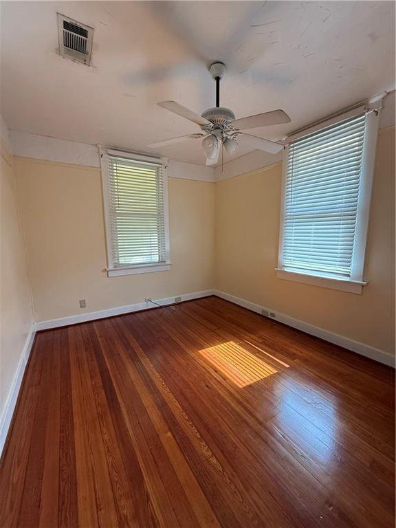 4218 S Liberty St, New Orleans, LA 70115 - empty room with wood-type flooring, baseboards, and ceiling fan