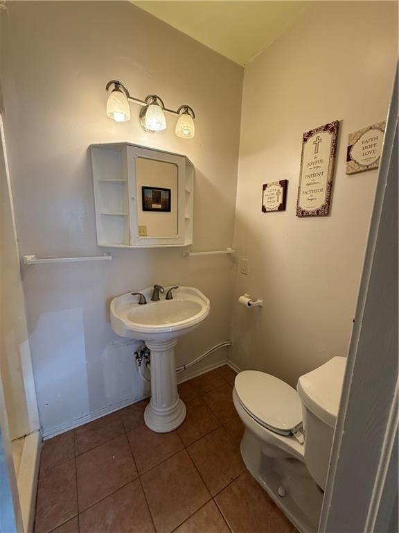 4218 S Liberty St, New Orleans, LA 70115 - half bathroom with toilet, tile patterned flooring, and baseboards