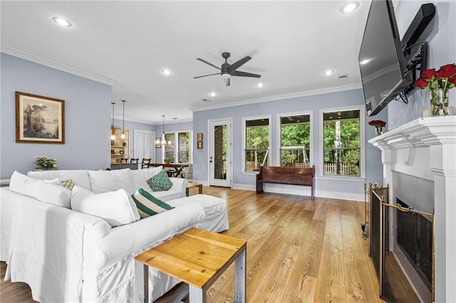 1180 Brook Ct, Mandeville, LA 70448 - living room featuring ceiling fan, ornamental molding, recessed lighting, baseboards, and a fireplace