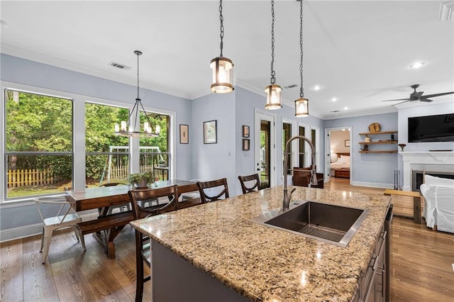 1180 Brook Ct, Mandeville, LA 70448 - kitchen with a sink, dark wood-style flooring, pendant lighting, ornamental molding, and baseboards