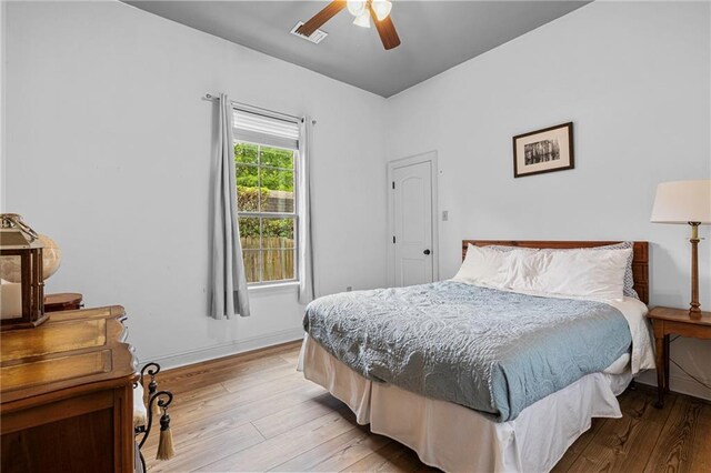 1180 Brook Ct, Mandeville, LA 70448 - bedroom featuring light wood-style flooring, a ceiling fan, and baseboards