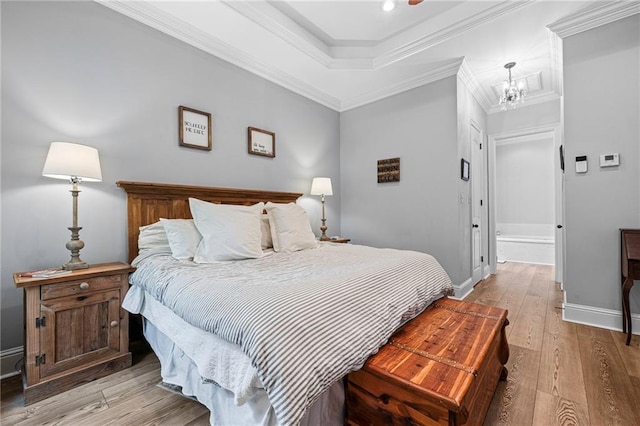 1180 Brook Ct, Mandeville, LA 70448 - bedroom featuring light wood-style floors, baseboards, a chandelier, and ornamental molding