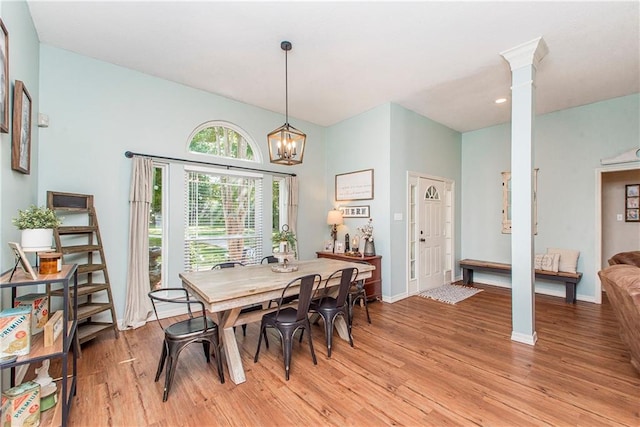 47380 Cardinal Dr, Franklinton, LA 70438 - dining room with light wood-type flooring, ornate columns, and a chandelier