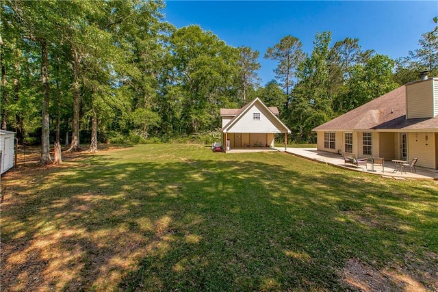 47380 Cardinal Dr, Franklinton, LA 70438 - view of grassy yard featuring a patio area and an outbuilding