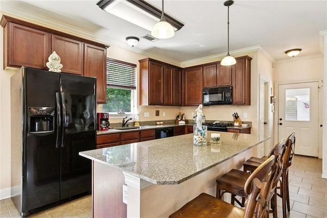 1216 W 23rd Ave, Covington, LA 70433 - kitchen with black appliances, a kitchen breakfast bar, light stone countertops, pendant lighting, and crown molding