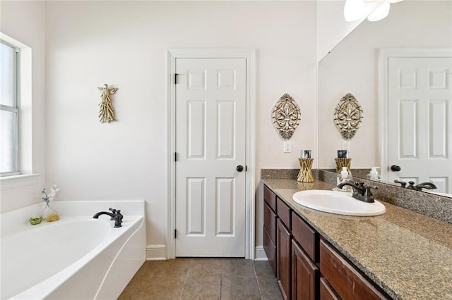 1216 W 23rd Ave, Covington, LA 70433 - bathroom featuring vanity, a bath, tile patterned floors, and baseboards