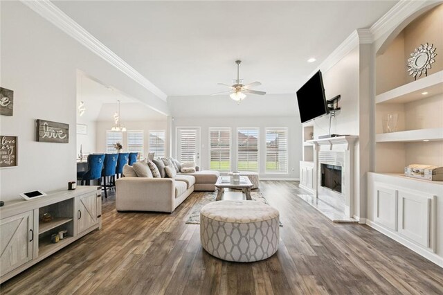 747 Belle Pointe Blvd, La Place, LA 70068 - living room featuring ceiling fan, a high end fireplace, crown molding, dark wood-style floors, and built in shelves