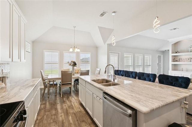 747 Belle Pointe Blvd, La Place, LA 70068 - kitchen featuring stainless steel appliances, a sink, vaulted ceiling, a chandelier, and light stone countertops