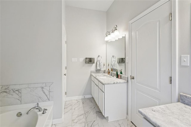 747 Belle Pointe Blvd, La Place, LA 70068 - full bathroom with vanity, marble look tile flooring, a garden tub, and baseboards