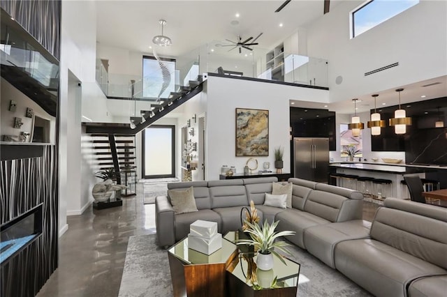 1900 Giuffrias Ave, Metairie, LA 70001 - living area with a high ceiling, plenty of natural light, ceiling fan, and stairway
