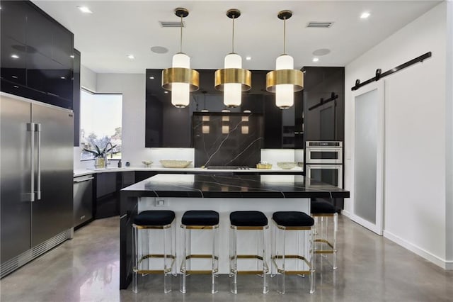 1900 Giuffrias Ave, Metairie, LA 70001 - kitchen with appliances with stainless steel finishes, finished concrete flooring, dark cabinetry, a center island, and recessed lighting