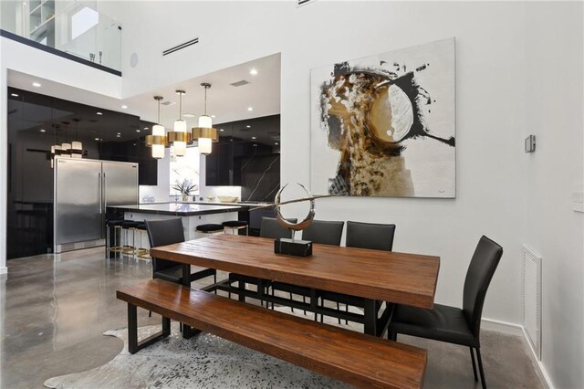 1900 Giuffrias Ave, Metairie, LA 70001 - dining space featuring a towering ceiling, finished concrete flooring, and recessed lighting