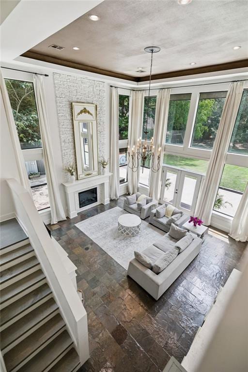 4 N Azalea Dr, Covington, LA 70433 - living room with plenty of natural light, a chandelier, a fireplace, recessed lighting, and dark stone finish flooring