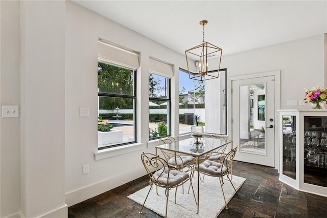 4 N Azalea Dr, Covington, LA 70433 - dining room featuring a chandelier, stone tile floors, and healthy amount of natural light