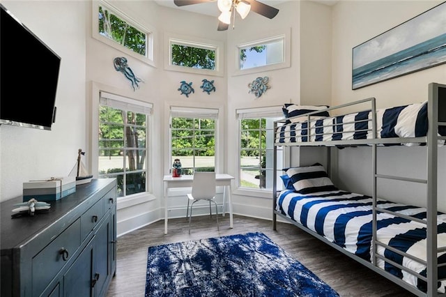 4 N Azalea Dr, Covington, LA 70433 - bedroom featuring multiple windows, baseboards, wood finished floors, and a towering ceiling