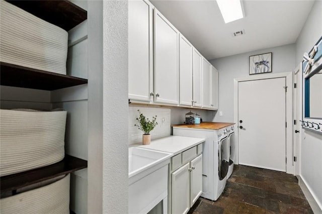 4 N Azalea Dr, Covington, LA 70433 - laundry room with washer and clothes dryer, dark stone finish flooring, and cabinet space