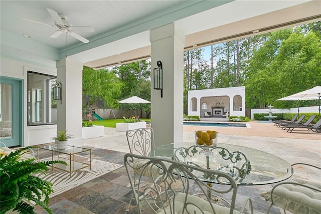 4 N Azalea Dr, Covington, LA 70433 - view of patio / terrace featuring a fireplace, ceiling fan, and outdoor dining area