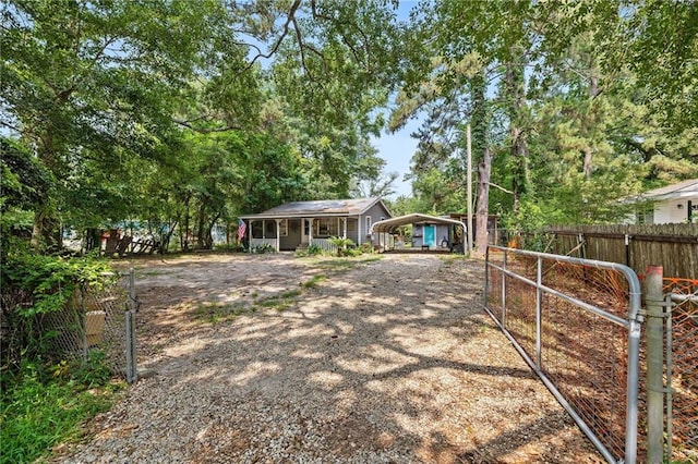 72272 Gurtner Dr, Abita Springs, LA 70420 - view of front facade featuring a detached carport and driveway