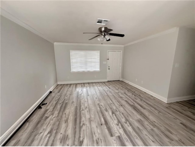 1438 Jasmine St, Mandeville, LA 70448 - unfurnished room with ornamental molding, a ceiling fan, baseboards, and wood finished floors