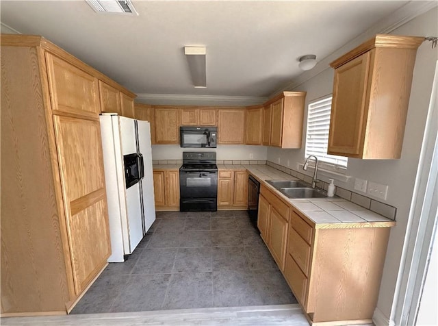 1438 Jasmine St, Mandeville, LA 70448 - kitchen with black appliances, a sink, tile counters, light tile patterned flooring, and crown molding