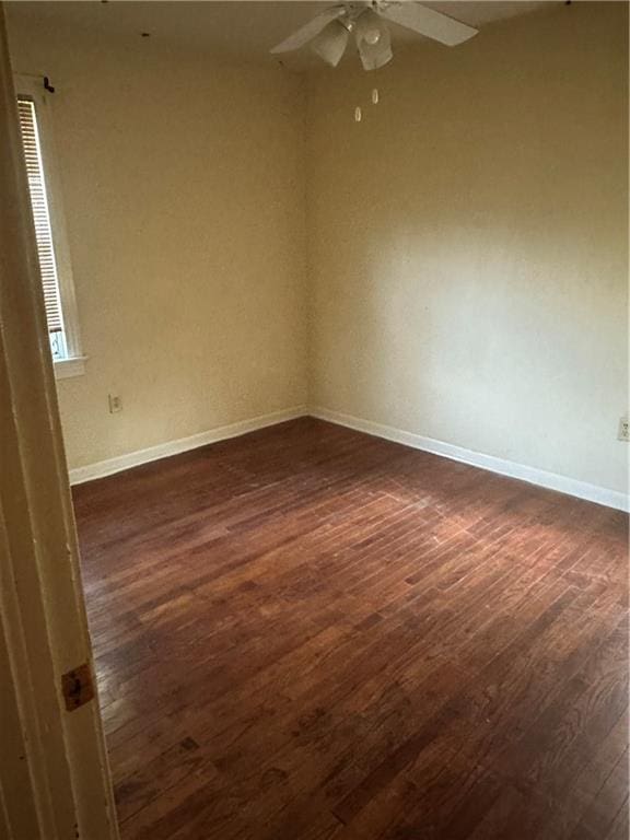 135 Bernice Ln, Ponchatoula, LA 70454 - empty room with dark wood-style flooring, ceiling fan, and baseboards