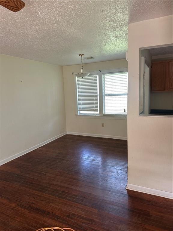 135 Bernice Ln, Ponchatoula, LA 70454 - empty room with a textured ceiling, dark wood-style flooring, and baseboards